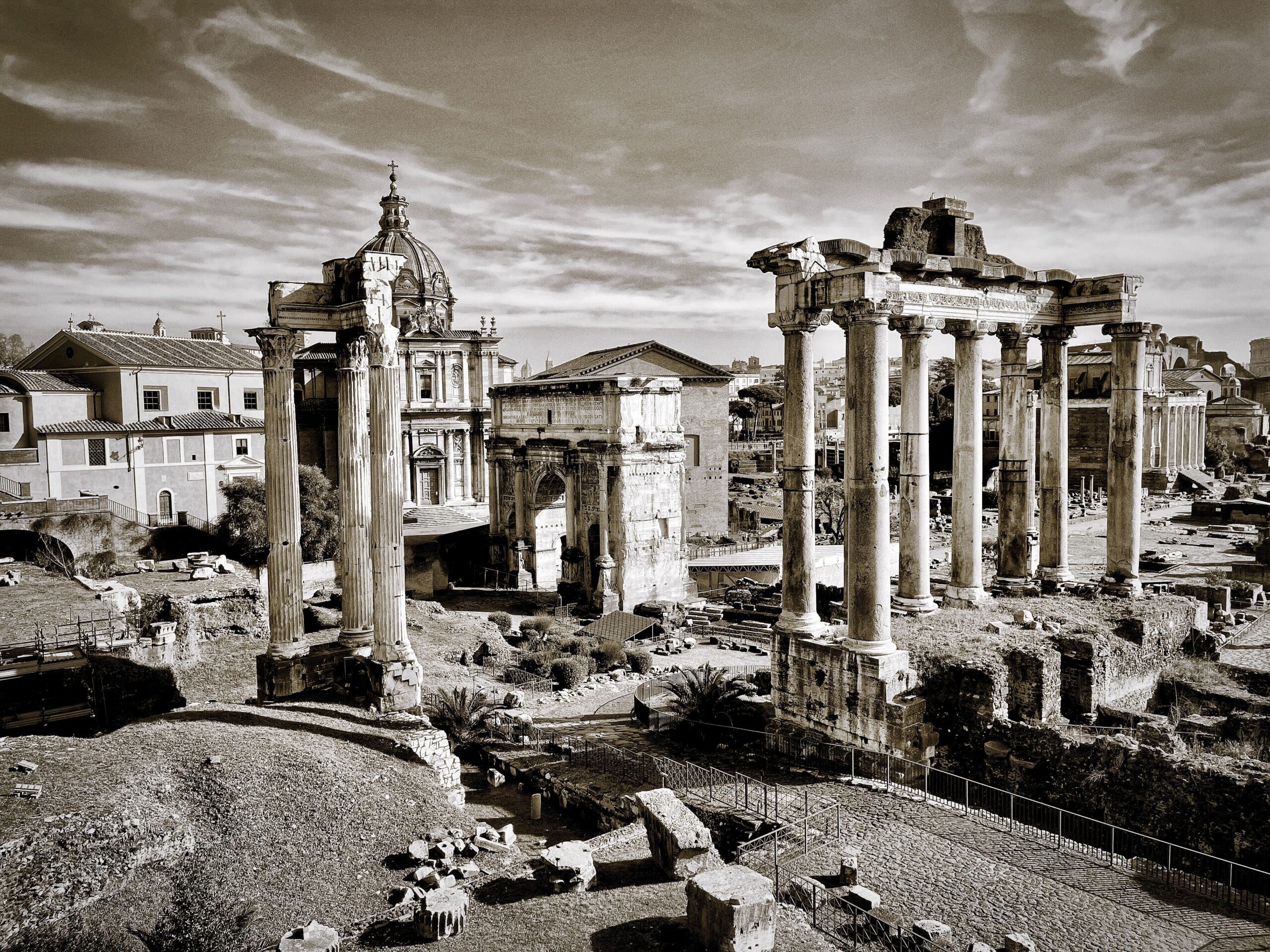 a black and white photo of ruins in a city